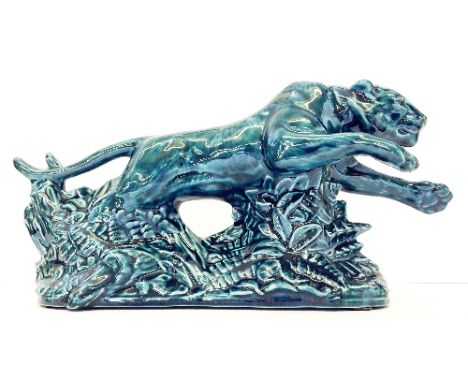 A Poole Zone blue glazed model of a Leaping Tiger (NB. This lot is sold with a Certificate relating to the Survival Range pro