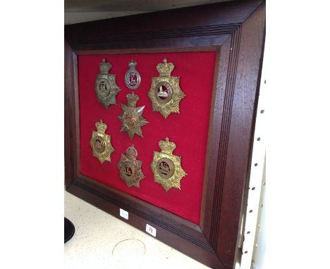 Seven various late 19th and early 20th century Police and Military cap and helmet badges.