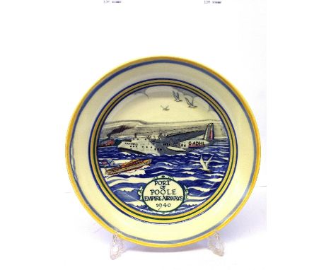 A Poole Pottery circular dish, decorated with a design of a Flying Boat in harbour scene, inscribed Port of Poole Empire Airw