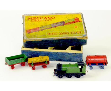 A DINKY TOYS MIXED GOODS TRAIN SET COMPRISING GREEN/BLACK ENGINE, GREEN/RED OPEN WAGON, RED/BLUE SHELL TANKER AND YELLOW/RED/