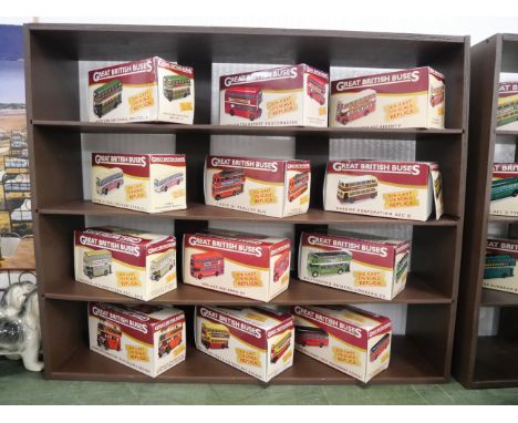 Twelve Great British Buses die-cast model buses, boxed and a shelving unit. To include Western National Bristol K, London Tra
