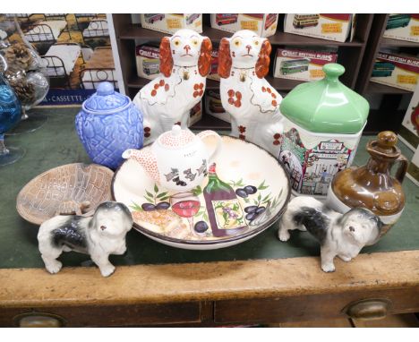A box of mixed china including a pair of Staffordshire spaniels, a Goose Fair storage/cookie jar, a Wade tortoise ashtray, a 