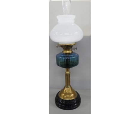 A brass oil lamp with blue glass reservoir **PLEASE NOTE THIS LOT IS NOT ELIGIBLE FOR IN-HOUSE POSTING AND PACKING** 