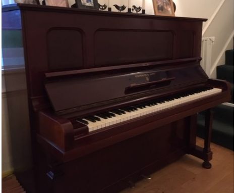Steinway (c1925) A Model K upright piano in a mahogany case.