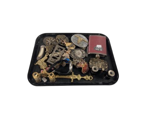 A tray of vintage belt buckles, a pair of field spectacles, a gents watch and a hip flask.