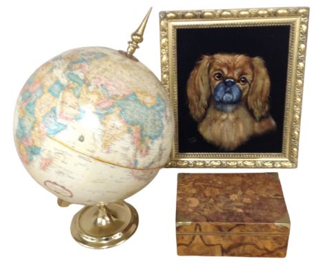 A contemporary portrait on fabric depicting a dog together with a desk globe and a wooden trinket box.