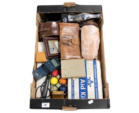 A box containing a salt rock lamp, snakeskin purse, first aid tin etc.