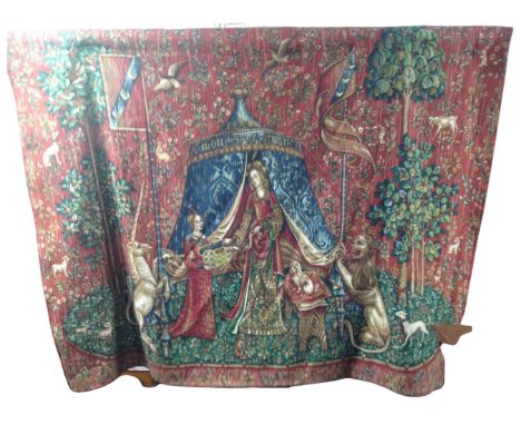 A traditional style embroidered tapestry hanging on metal rail 