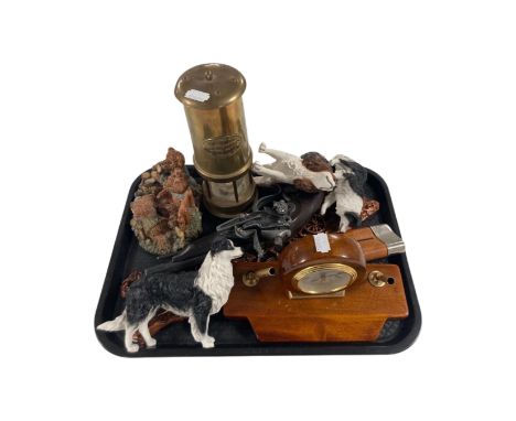 A tray containing modern dog ornaments, a desk clock, a reproduction pistol and a miner's lamp.