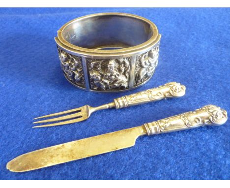 An unusual miniature white metal single place Cutlery Setting comprising Knife and Fork engraved with an armorial crest (make
