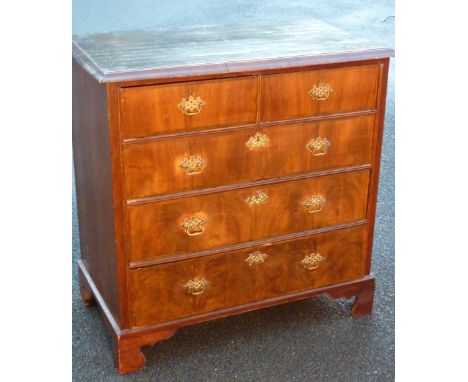 An early 18th Century walnut Chest, the quarter veneered crossbanded and herringbone banded moulded top above two half width 