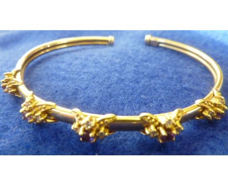A ladies 9 carat yellow gold Bangle, five flower head style designs centrally set with amethysts surrounded by white stones, 