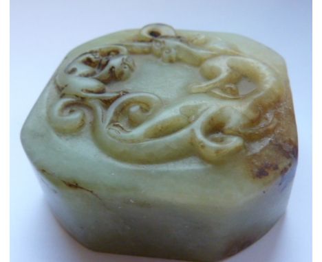 A 19th Century (possibly earlier) Chinese Celadon jade Seal of square section with canted corners, the top carved in relief w