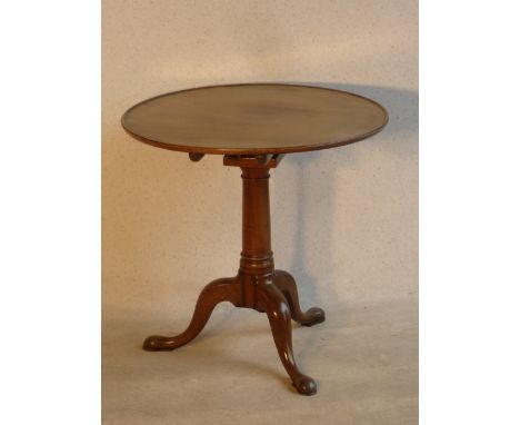 A mid 18th Century circular mahogany tilt top Occasional Table with "bird cage" mechanism, gun barrel stem and on tripod base