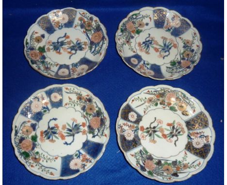 Four Chinese Imari Saucers, Kangxi period (1662-1722) each with scalloped rim and decorated with panels of flowers, each 18.5