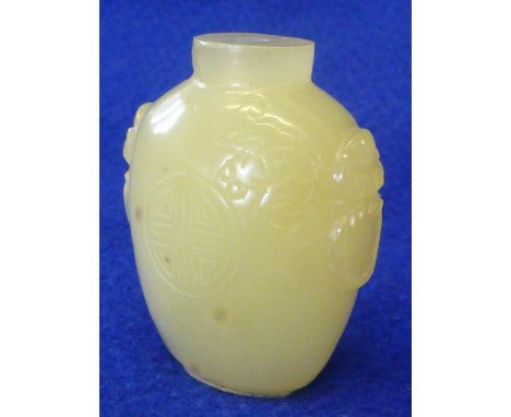 A heavy Chinese jade Snuff Bottle, the two sides carved in relief with lion mask and ring style "handles", the front section 