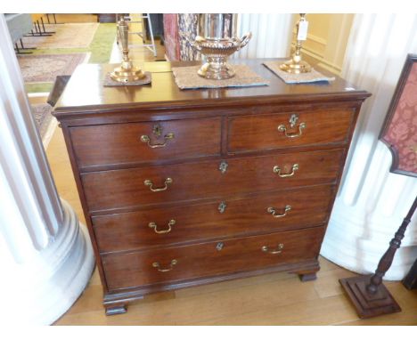 A late 18th Century mahogany Chest, the moulded top above two half width and three full width graduated drawers, raised on og