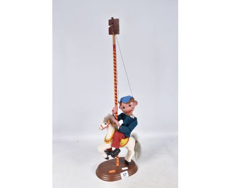 AN UNBOXED PELHAM SM BOY PUPPET RIDING ON A CAROUSEL HORSE, puppet appears complete and in fairly good condition with some mi