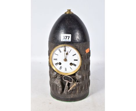 A TRENCH ART MANTLE CLOCK FORMED FROM A BOMB CASING, fitted with a late 19th century enamel dial and roman numerals, 8 day mo