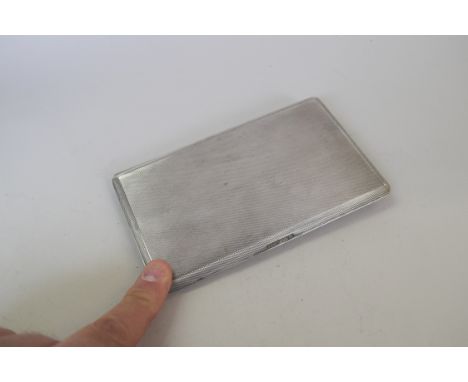 A engine turned silver rectangular cigarette case, by The Goldsmiths & Silversmiths Co Ltd, 14 x 8 cm, 177g. Condition Report