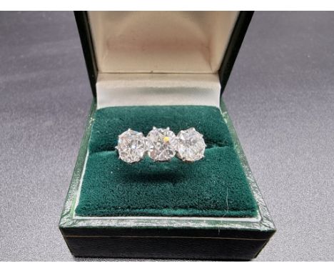 A diamond three stone old mine cut ring, estimated at over 3ct, stamped 18ct plat, size N.