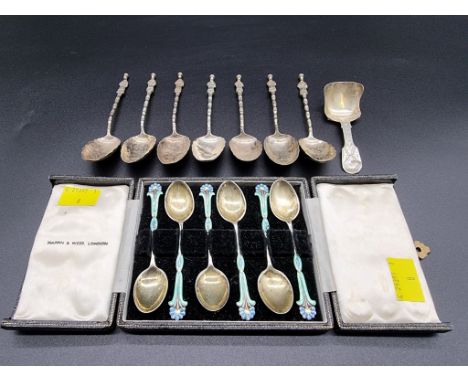 A cased set of six silver and enamel coffee spoons; together with a Victorian silver caddy spoon; and a set of seven Chinese 