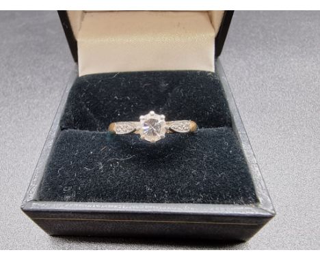 A yellow metal ring set solitaire diamond, of approximately 0.25ct,&nbsp;with diamond chip set shoulders, stamped 18ct/plat, 