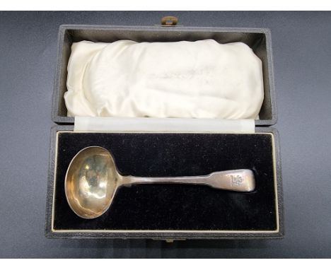 A cased George III silver fiddle pattern sauce ladle, by Thomas Wilkes Barker, London 1806, 64g. 