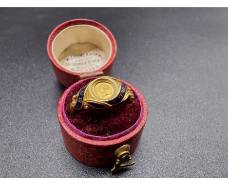 A Victoria &amp; Albert commemorative yellow metal and blue enamel ring, decorated portrait busts to the reverse and the mott