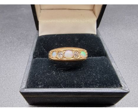 An 18ct gold opal and diamond five stone ring, size M 1/2, gross weight 3.6g. 