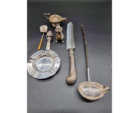 A group of silver items, to include; a baby's rattle with mother of pearl handle; a silver ashtray and a toddy ladle with bal