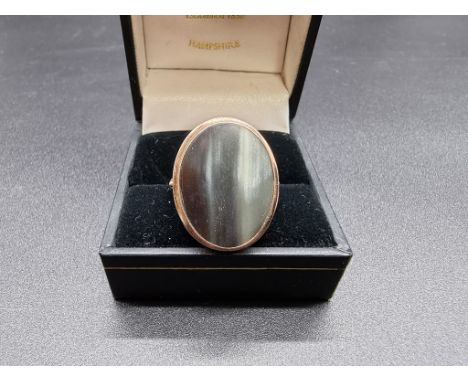 A yellow metal ring set oval horn, stamped 14k, size P-P 1/2. 