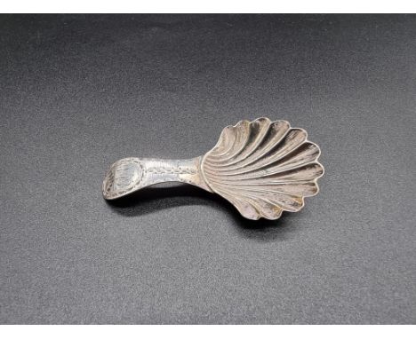 A George III bright cut silver tea caddy spoon, having shell shaped bowl, by Hester Bateman, London 1784, 7.5cm, 8.5g. 
