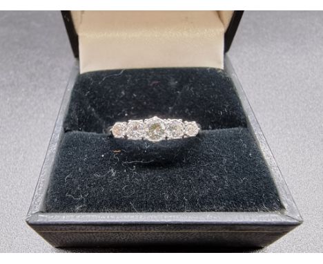 An 18ct gold and platinum diamond five stone ring, size M 1/2, gross weight 2.5g. 