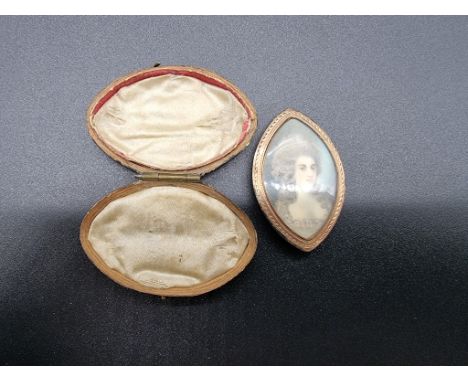 A Georgian rolled gold brooch/pendant, set with painted portrait of a lady, 45mm, in a fitted case. 
