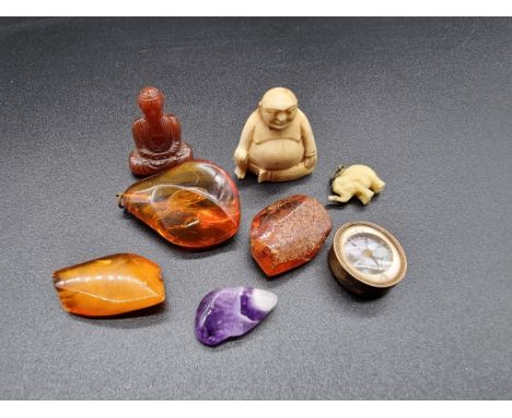 An amber pendant, 33mm, 5g; together with seven other items to include a Singers patent fob compass. 