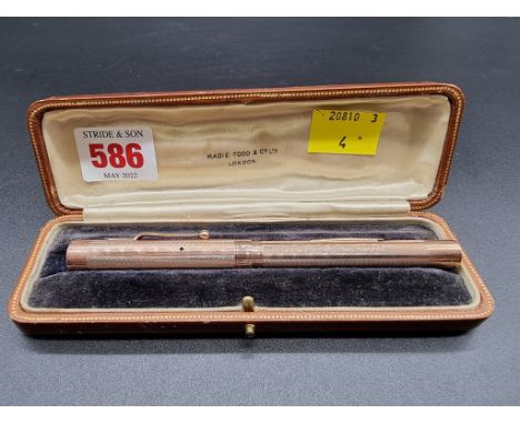 A cased engine turned 9ct gold Mabie Todd &amp; Co 'Swan' fountain pen, London 1934, having 14ct nib, 13.5cm. 