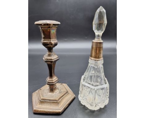 A silver mounted cut glass scent bottle, Birmingham 1929, 19cm high; together with a silver candlestick. 