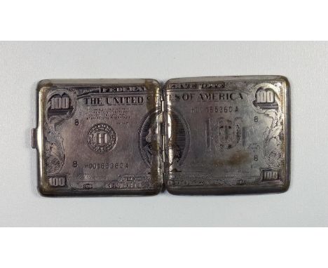 A 1920'S SILVER PLATED CIGARETTE CASE IN THE FORM OF A $100 DOLLAR BILL, BEARING THE IMAGE OF BENJAMIN FRANKLIN, WITH AN ENGI