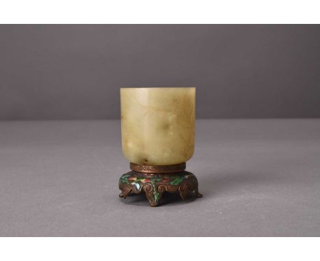 A Chinese nephrite jade and enamelled bronze beaker vase, Qing DynastyThe beaker of pale green hue, incised with stylised lot