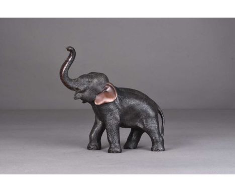 A Japanese bronze figure of an elephant, Meiji eraStanding four square with trunk raised in salute.19cm long x 18cm high