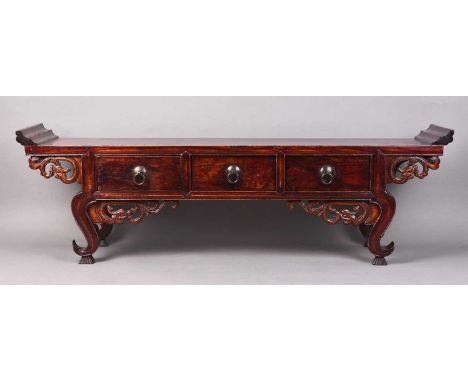 A Chinese lacquered softwood calligraphy tableLate Qing Dynasty, the moulded top above three frieze drawers, raised on scroll