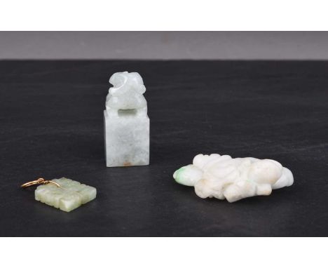 Three Chinese jadeite carvings, Qing DynastyIncluding: A miniature seal carved with a guardian lion, 3cm; a pendant carved as