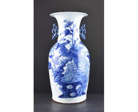 A Chinese blue and white baluster vase, late Qing DynastyWith pierced scroll handles, decorated with a peacock perched on a r