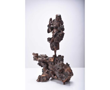 Three Chinese carved wood figures of Luohan, Qing Dynasty The first modelled standing and holding a scroll, 31cm high, the se