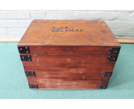A wooden chest marked L.Hicks with contents including leather boots and a hand axe etc