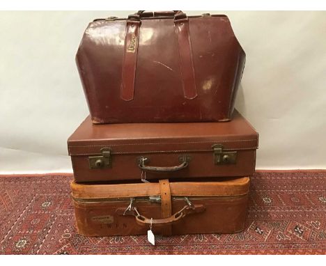 Three vintage leather suitcases