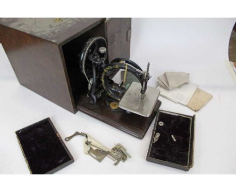 Vintage Wilcox and Gibbs sewing machine in wooden case