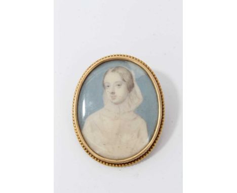 19th century ivory portrait miniature depicting a young girl dressed in all white, in gilt metal brooch mount. 55mm x 45mm 