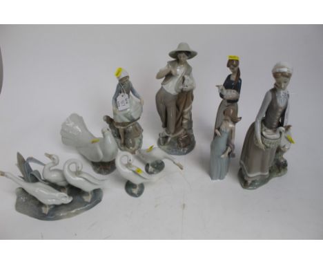 Group of nine Lladro porcelain figures including lady with geese, lady with rabbit, girl with lamb etc